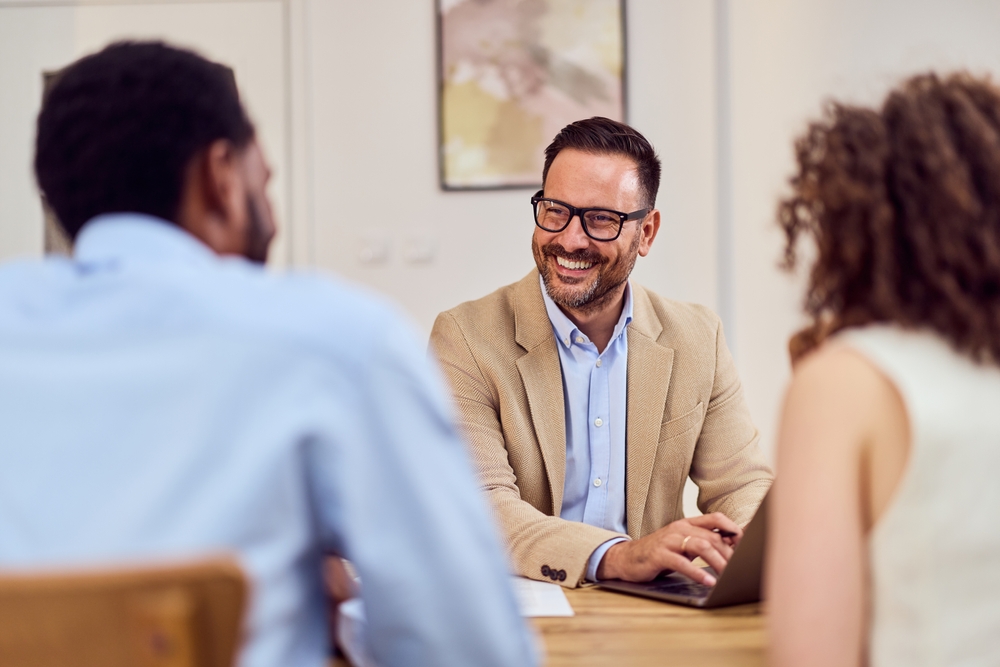 property manager speaking with a couple during a consultation