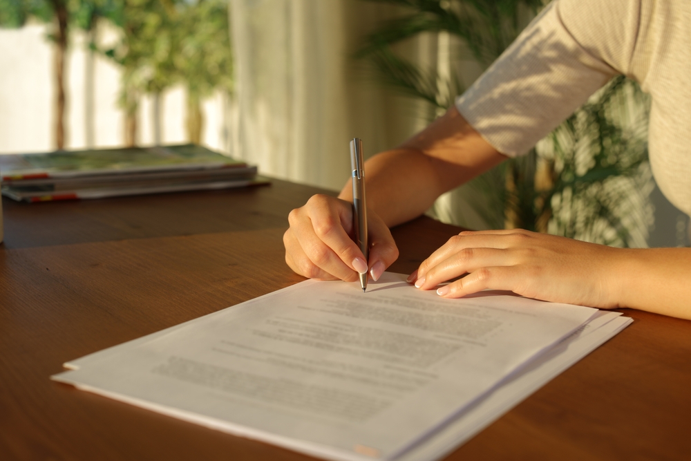 woman completing paperwork for a rental property damage claim