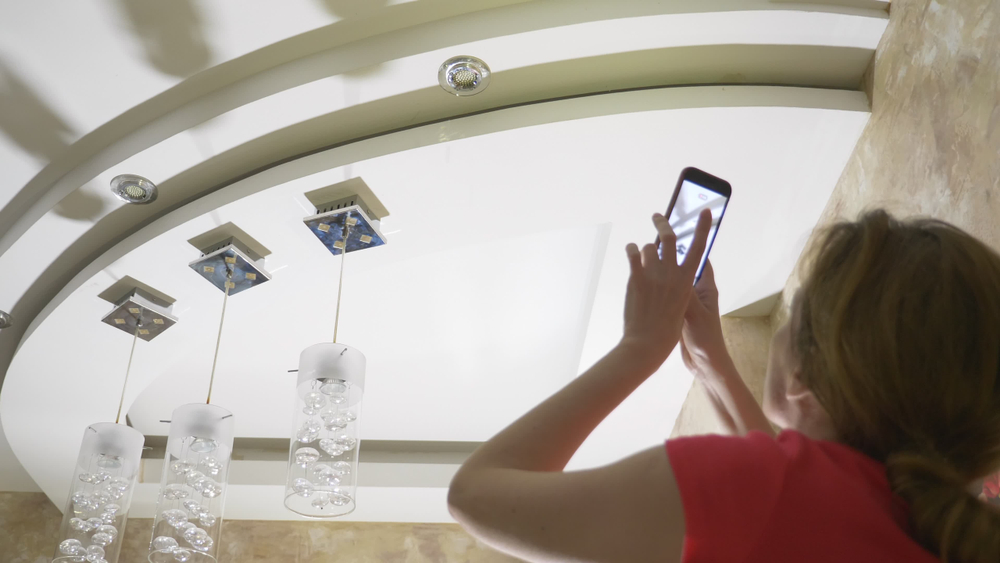 woman documenting damage to fixtures